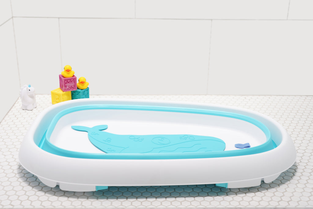 Baby sitting in the Original Tubee Tub safety bathtub – ergonomic and non-slip bath tub designed for newborn comfort and support during bath time