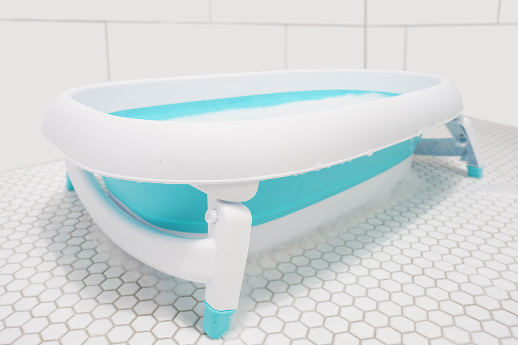 Baby sitting in the Original Tubee Tub safety bathtub – ergonomic and non-slip bath tub designed for newborn comfort and support during bath time